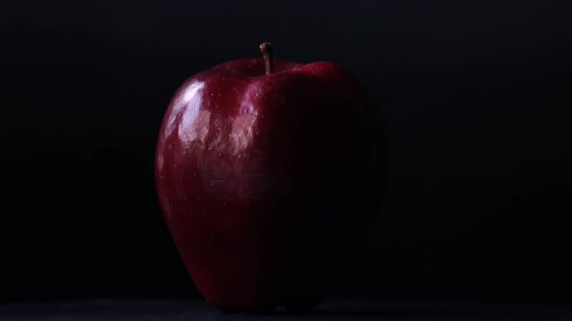Close up of a delicious fresh and crisp red apple with black background.