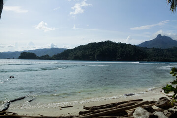 Beautiful landscape of tropical beach with white sand and turquoise water. Beach with mountain background