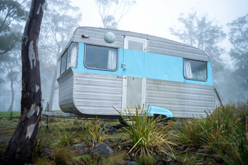 vintage Caravan camping at a campground off grid on a holiday in fog in the forest