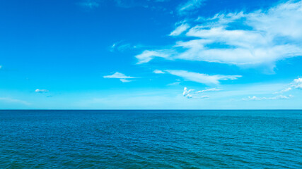 Nature of the beach and sea Summer with sunshine, sandy beaches, clear blue waters sparkling against the blue sky. On an island with good ecology and environment Background for summer vacation concept