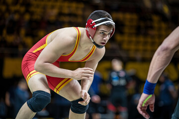 Close-up of a focused wrestler in a crouched stance, ready to grapple