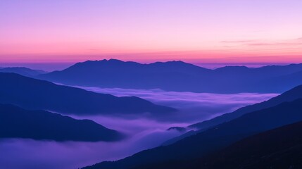 Serene mountain landscape at dawn, with mist filling the valleys under a colorful sky.