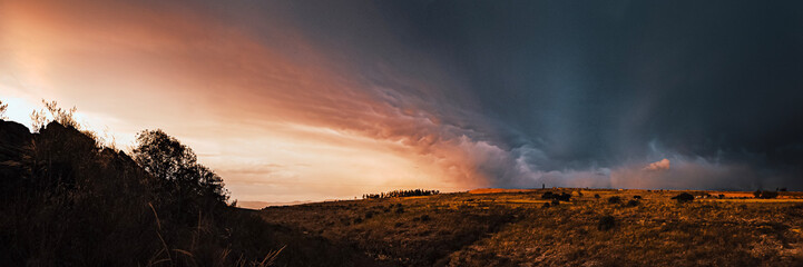 Panoramic sunset landscape with clouds and dirt ground