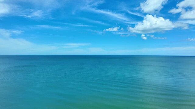 Nature of the beach and sea Summer with sunshine, sandy beaches, clear blue waters sparkling against the blue sky. On an island with good ecology and environment Background for summer vacation concept