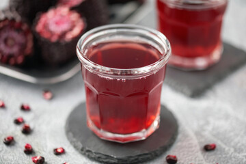 Chicha morada. Purple corn juice in glass on wooden table. Sweet traditional peruvian drink