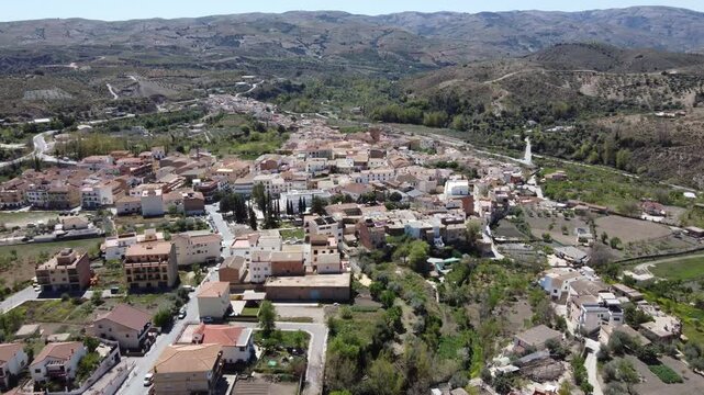 Aerial approach to Cadiar, in the Alpujarras area, Granada, Spain. Sea in the background