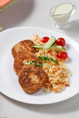 Vibrant Turkey Cutlets with Rice and Vegetables on a Light Background