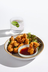 Crispy Chicken Strips with Sweet Chili Sauce Minimalist Gourmet in High Contrast Lighting