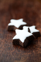Christmas cookies (cinnamon stars) on dark background. Close up.