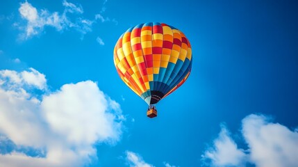 Fototapeta premium Colorful balloon floats among picturesque clouds