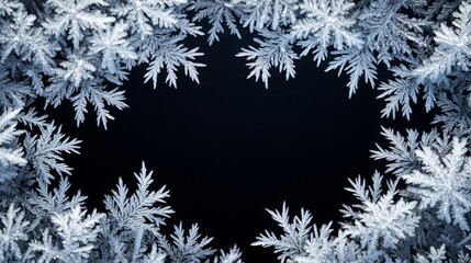 Frosty pattern frame on a black background. Winter overlay design with place for text. Frost on the glass, freezing effect. Christmas crystals concept copy space banner.