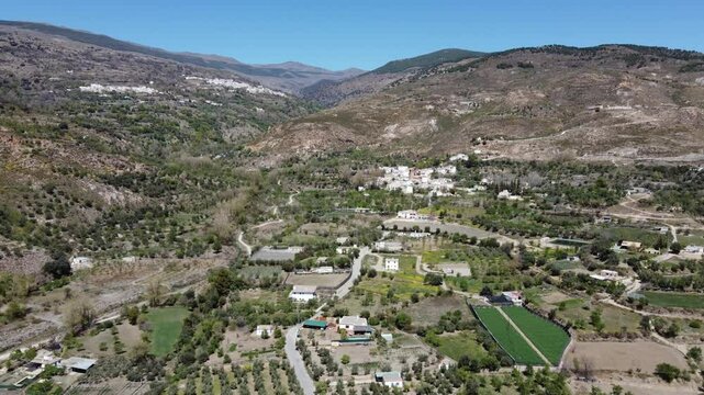 Aerial view over Las Alpujarras district, Granada, with the Sierra Nevada in the background. Villages of Alcutar and Berchules