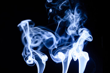 Captivating dance of smoke wisps against a dark backdrop, revealing delicate patterns and ethereal forms