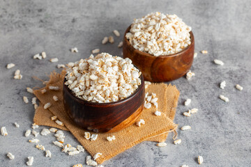 Khoi is a puffed rice snack, light and crispy, commonly enjoyed in Bengal, used in traditional dishes and rituals.