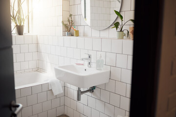 Bathroom, interior and empty in home with basin, bath and sunshine with mirror for cleaning...