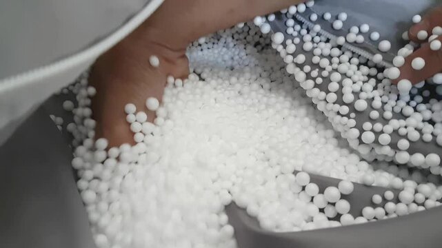 white styrofoam granules on cloth, usually used to fill bean bags or relaxing sofas.
