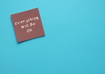 Brown paper on blue copy space background with text written Everything Will Be OK - phrase of...