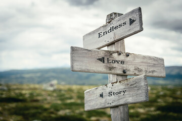 endless love story text quote written on wooden signpost at the crossroads outdoors in nature.