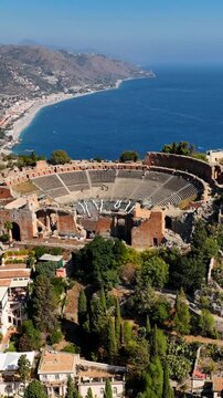 Ancient Theater of Taormina in Sicily, Italy.
Spectacular aerial view of the Greek Amphitheater, tourist attraction for foreign visitors. Sicilia, Italia.