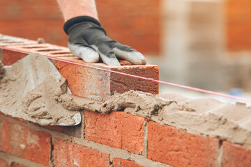 Crafting a sturdy wall with precision in a construction site during daylight