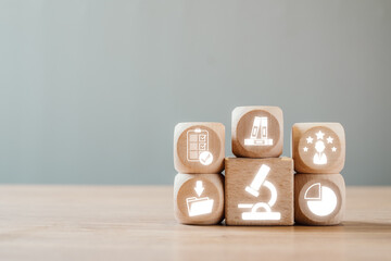 Wooden blocks with icons representing case study elements for business and education analysis.