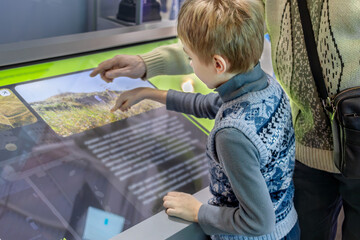 Father and Son Exploring Technology Together on Interactive Screen