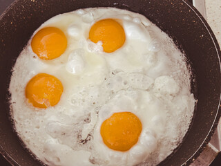 A pan of eggs is cooking on a stove