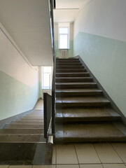 Fototapeta premium A staircase in a building with a white and green wall