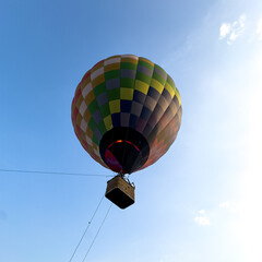 A colorful hot air balloon is floating in the sky
