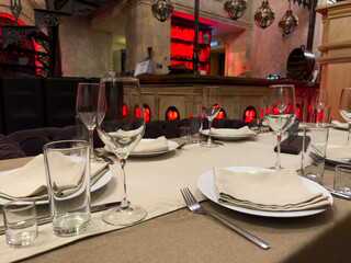 A table with a white tablecloth and a red background