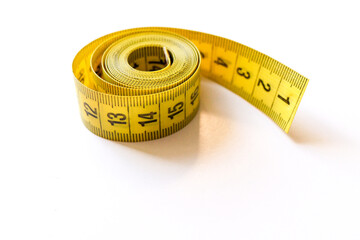 Yellow measuring tape isolated on white background. High quality photo