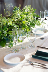 An inviting and beautifully arranged table set with exquisite glassware, elegant plates, and a vibrant floral centerpiece, making it ideal for weddings, parties, or various celebrations