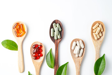 Top view Variety of vitamin and mineral pills in wooden spoon, Dietary supplement healthcare
