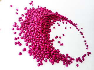 Hot cutting type masterbatch granules, pink plastic raw material resin coloring pigment granules, isolated with full color background for industrial plastic company profile product catalog design