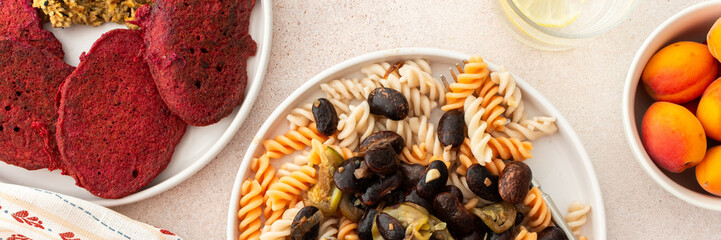 Zucchini and broccoli pancakes served with a mixed salad of cucumbers, young peas, and radishes. This healthy vegetarian dish is both delicious and nutritious