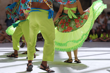 Dancers dancing and wearing one of the traditional folk costume from Brazil