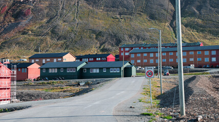 Colorful buildings line the road in Longyearbyen Svalbard on a clear sunny day