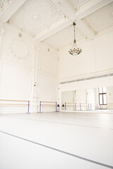 Studio with white walls and open space for ballet and yoga classes