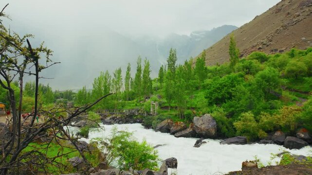 Pedestrian bridge crossing Indus River during daytime in Soq Valley in Skardu, northern Pakistan