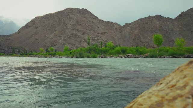 Indus River flowing in Soq Valley during a cloudy daytime in Skardu, Gilgit-Baltistan, Pakistan