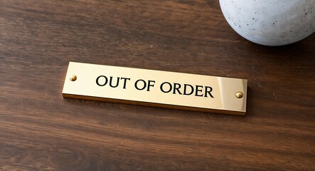 out of order engraved text on gold name plate sign 