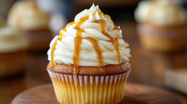 Vanilla cupcake topped with creamy frosting and drizzled caramel