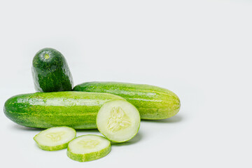 Fresh Green cucumber and slice cucumber arranged and harvested on white background . Cucumbers contain important vitamins and minerals, including vitamin K, vitamin C, potassium, and magnesium, etc.
