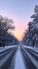 Obraz premium A snowy road with trees covered in snow along the sides, an empty asphalt highway, and trees on both sides at sunrise