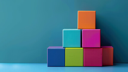 Obraz premium Colorful blocks stacked creatively against teal background, showcasing vibrant and playful arrangement. This evokes sense of fun and creativity