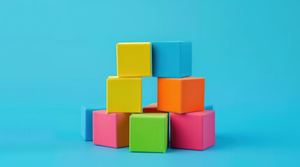 Obraz premium Colorful building blocks arranged in playful structure against bright blue background, evoking creativity and fun. Perfect for educational themes and childrens activities