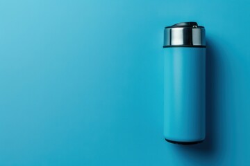 Blue insulated travel mug on a solid blue background