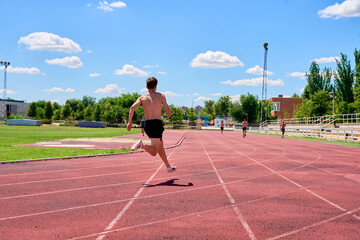 Sprinter running on track during group training