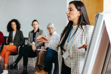 Successful woman sharing expertise with group of professionals during workshop