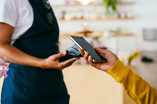 Bakery, happy portrait of black woman in cafe ready for serving pastry, coffee and baked foods. Restaurant, coffee shop and confident waiter barista by counter for service, help and welcome